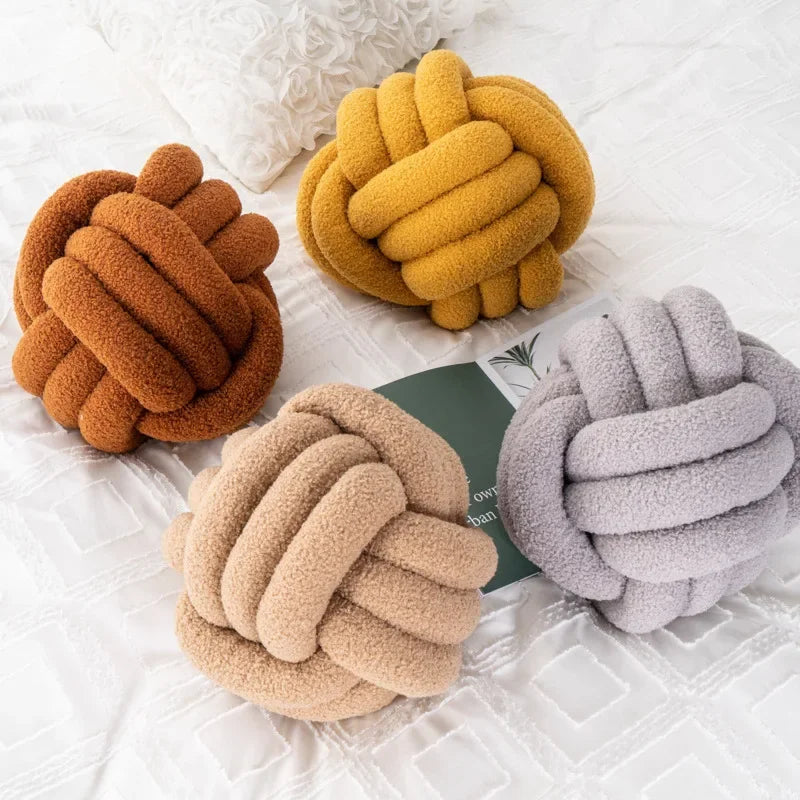Decorative plush pillow with an aesthetically pleasing globe-shaped knot, ideal for sleeping