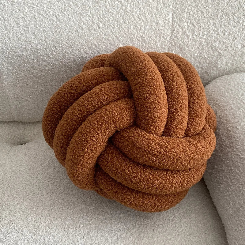 Decorative plush pillow with an aesthetically pleasing globe-shaped knot, ideal for sleeping