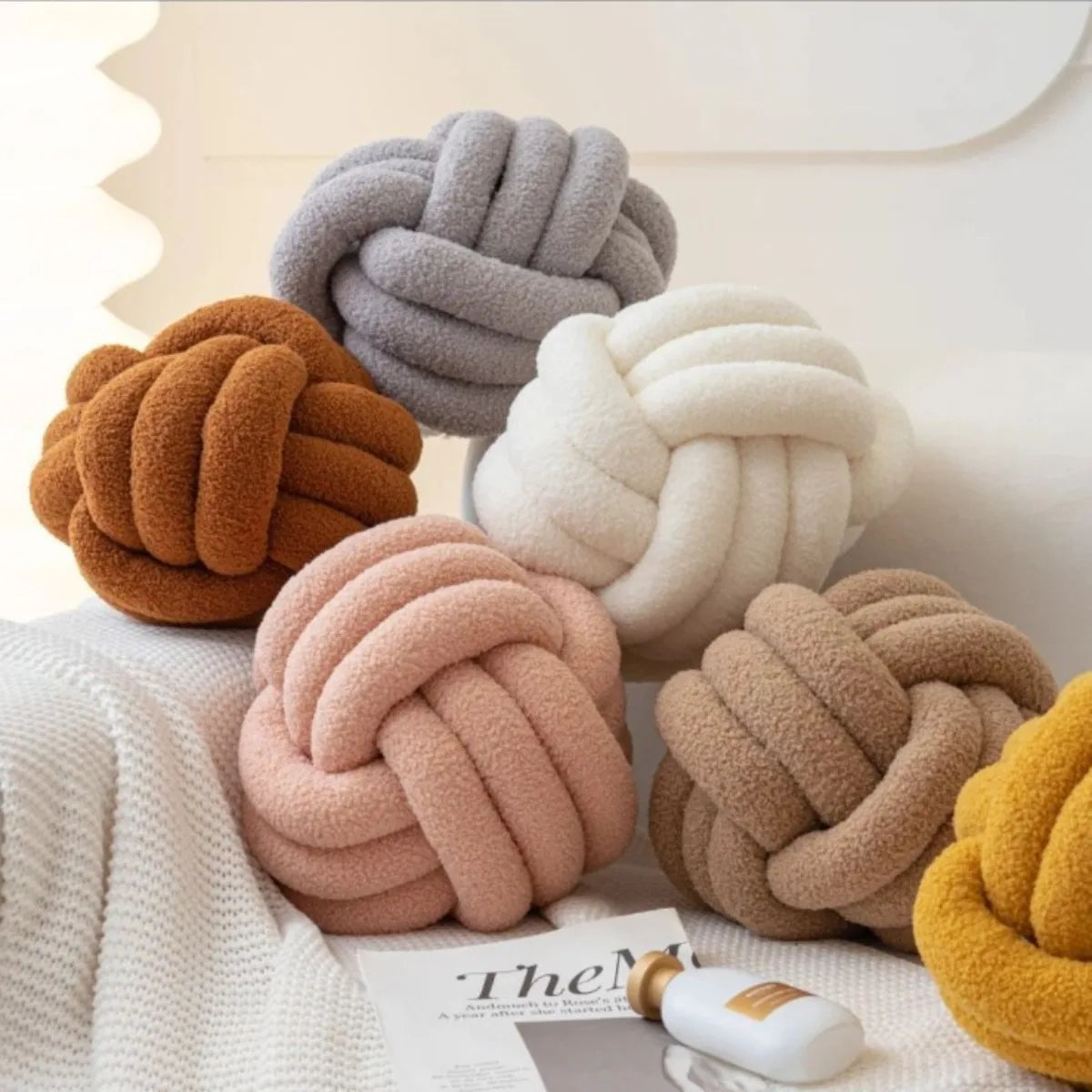 Decorative plush pillow with an aesthetically pleasing globe-shaped knot, ideal for sleeping