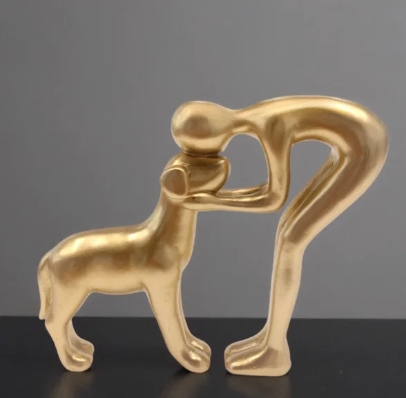 Resin figurine of a puppy and its owner - table ornament interior decoration model.