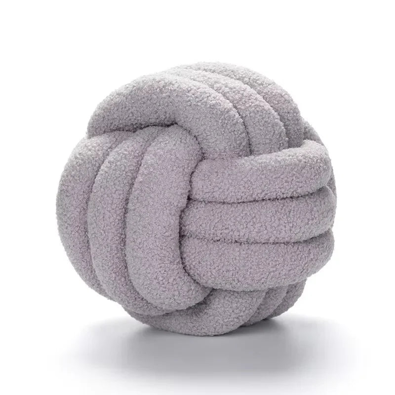 Decorative plush pillow with an aesthetically pleasing globe-shaped knot, ideal for sleeping